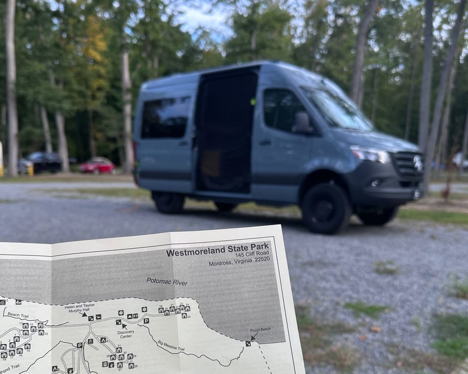 A Westmoreland State Park map in the foreground with an adventure van in the blurred background.